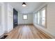 Bright living room with wood floors, shiplap walls, built-in shelving, and an electric fireplace at 1515 Dawson St, Indianapolis, IN 46203