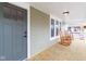 Inviting porch with wooden floors, comfortable rocking chairs, and a stylish front door for a warm welcome at 1515 Dawson St, Indianapolis, IN 46203