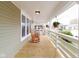 Relaxing front porch with wooden floors, classic rocking chairs, and white railings, perfect for enjoying the outdoors at 1515 Dawson St, Indianapolis, IN 46203