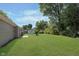 Expansive backyard with healthy green lawn and mature landscaping near a home with neutral siding at 1528 N Dukane Way, Indianapolis, IN 46214