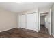 Spacious bedroom with neutral walls, hardwood floors, and a double door closet at 1528 N Dukane Way, Indianapolis, IN 46214