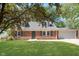 Charming brick home features a well-maintained lawn and a two-car garage at 1528 N Dukane Way, Indianapolis, IN 46214