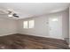 Bright living room with modern ceiling fan, luxury vinyl flooring, and large windows at 1528 N Dukane Way, Indianapolis, IN 46214