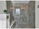 Modern bathroom featuring an expansive shower with glass doors, a built-in bench, and gray tile at 16060 Barringer Ct, Westfield, IN 46074