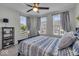 Cozy bedroom with a ceiling fan, three windows, and a blue-patterned bedspread at 16060 Barringer Ct, Westfield, IN 46074