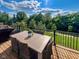 Inviting deck featuring a dining area, complete with a grill, and a serene view of lush greenery at 16060 Barringer Ct, Westfield, IN 46074