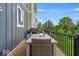 The covered deck has outdoor seating, a grill and a view of the backyard at 16060 Barringer Ct, Westfield, IN 46074