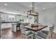 Bright dining area showcases stylish light fixture, wood table, and coordinating chairs, creating a perfect spot for meals at 16060 Barringer Ct, Westfield, IN 46074