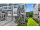Attractive townhouse exterior with gray and brick, showcasing a well-maintained lawn and garden at 16060 Barringer Ct, Westfield, IN 46074