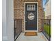 Inviting front door with brick surround, a 'welcome' mat, and decorative 'hello friends' sign at 16060 Barringer Ct, Westfield, IN 46074