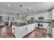 Open concept kitchen featuring a large island, stainless steel appliances, and white cabinetry, perfect for modern living at 16060 Barringer Ct, Westfield, IN 46074