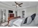 Relaxing main bedroom with TV, featuring elegant decor and a walk-in closet for ample storage and organization at 16060 Barringer Ct, Westfield, IN 46074