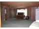 Spacious basement area with wood paneling, exposed brick, and lots of natural light; needs some TLC at 1700 S Perdieu Rd, Muncie, IN 47302