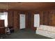 Finished basement area showcasing classic wood paneling, neutral carpets, and plenty of natural light at 1700 S Perdieu Rd, Muncie, IN 47302