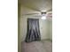 Cozy bedroom featuring plush carpeting, neutral walls, and a window with light-blocking curtains at 1700 S Perdieu Rd, Muncie, IN 47302