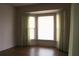 Bedroom featuring bay window, hardwood floors, neutral walls, and light-colored curtains at 1700 S Perdieu Rd, Muncie, IN 47302