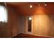 Cozy bedroom featuring wood-paneled walls, carpeted floor, and ample light fixtures in ceiling at 1700 S Perdieu Rd, Muncie, IN 47302