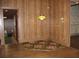 Vintage dining room with wood paneling, hardwood floors, and hanging light fixture at 1700 S Perdieu Rd, Muncie, IN 47302