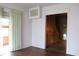 Entryway with hardwood floors and view into another room with wood paneled walls at 1700 S Perdieu Rd, Muncie, IN 47302