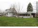 A charming home featuring a sun room and large lawn in a quiet neighborhood at 1700 S Perdieu Rd, Muncie, IN 47302