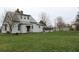 Charming two-story home with large yard and an enclosed porch, perfect for relaxing or entertaining guests at 1700 S Perdieu Rd, Muncie, IN 47302