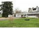 Inviting home featuring a spacious yard, detached garage, and long driveway for ample parking at 1700 S Perdieu Rd, Muncie, IN 47302