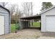 View of the detached garage and carport, providing ample storage for vehicles and equipment at 1700 S Perdieu Rd, Muncie, IN 47302