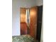 Hallway featuring wood floors, patterned wallpaper, and view into another room at 1700 S Perdieu Rd, Muncie, IN 47302
