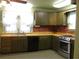 Classic kitchen design with neutral cabinets, brick backsplash, and stainless steel appliances; retro design at 1700 S Perdieu Rd, Muncie, IN 47302