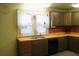 Classic kitchen featuring wooden cabinets, a brick backsplash, laminate counters, and stainless steel appliances at 1700 S Perdieu Rd, Muncie, IN 47302