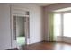 Spacious room with bay window, hardwood floors, and view into another room at 1700 S Perdieu Rd, Muncie, IN 47302