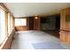 Sun Room featuring paneled walls, linoleum ceiling, and large windows overlooking the yard at 1700 S Perdieu Rd, Muncie, IN 47302