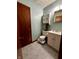 Compact bathroom with a toilet, vanity, and cabinet, perfect for essential needs at 1706 Manor Dr, Lebanon, IN 46052
