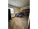 Functional bedroom with a comfortable chair, window, and built-in shelving for storage or display at 1706 Manor Dr, Lebanon, IN 46052