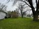 Expansive front yard showcasing lush green lawn and mature trees enhancing the property's curb appeal at 1706 Manor Dr, Lebanon, IN 46052