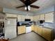 Functional kitchen with painted cabinetry, complete with standard appliances and ample counter space at 1706 Manor Dr, Lebanon, IN 46052
