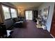 Versatile living room with a reclining sofa, desk area, and access to the outside through sliding doors at 1706 Manor Dr, Lebanon, IN 46052