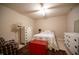 Inviting bedroom featuring neutral decor, a ceiling fan, and a vibrant red chest at 172 Arabian Ct, Whiteland, IN 46184