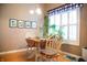 Charming dining area features a light wood table, decorative plants, and a window with natural light at 172 Arabian Ct, Whiteland, IN 46184