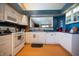 Bright kitchen featuring white cabinets, wood flooring, modern appliances, and a functional layout at 172 Arabian Ct, Whiteland, IN 46184