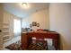 Bright home office featuring a large desk, stylish rug, and natural light from the window at 172 Arabian Ct, Whiteland, IN 46184