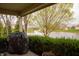 Covered patio with a grill overlooking a scenic view of a pond with a fountain at 172 Arabian Ct, Whiteland, IN 46184