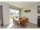 Cozy dining area with wood table and chairs, filled with natural light from sliding glass doors at 181 Kiawah Dr, Whiteland, IN 46184