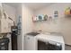 Efficient laundry room features modern appliances, shelving, and a water purification system at 181 Kiawah Dr, Whiteland, IN 46184