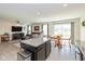 Bright living space with open floor plan, dark cabinetry, and dining area by sliding glass doors at 181 Kiawah Dr, Whiteland, IN 46184