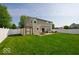 Spacious backyard featuring a well-maintained lawn, a storage shed, and an outdoor dining set at 2009 Quarter Path Rd, Cicero, IN 46034