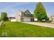 Charming two-story home with a well-manicured lawn, an attached garage, and appealing curb appeal at 2009 Quarter Path Rd, Cicero, IN 46034