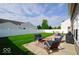 Relaxing patio area with comfortable seating, a coffee table, and a manicured lawn perfect for outdoor enjoyment at 2009 Quarter Path Rd, Cicero, IN 46034