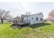 The backyard has a wooden deck and green grass at 218 Illinois St, Shirley, IN 47384