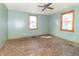 Bedroom features light blue walls, a window, and hardwood floors ready for finishing at 218 Illinois St, Shirley, IN 47384